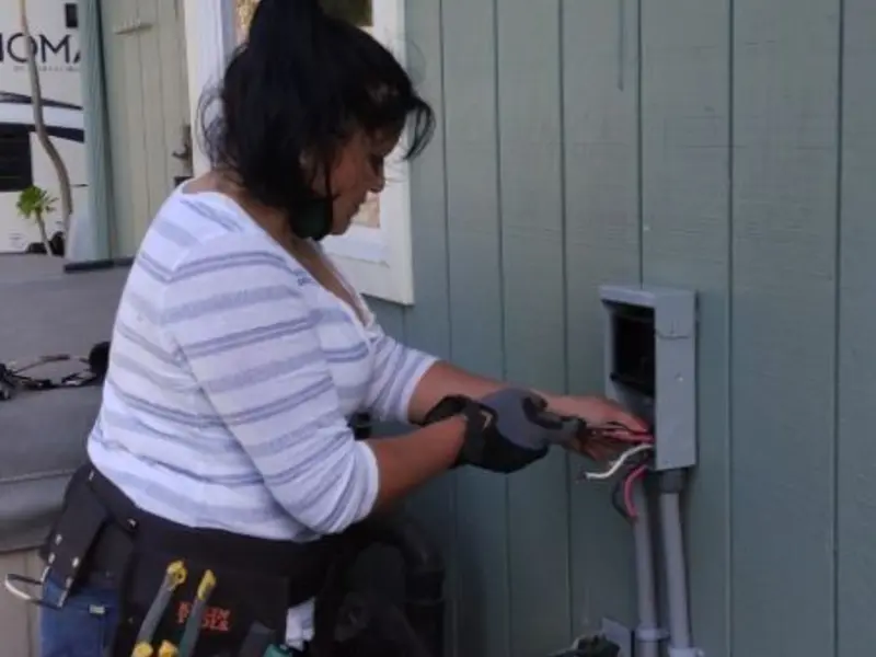 Licensed electrician wiring an exterior subpanel in Alpine